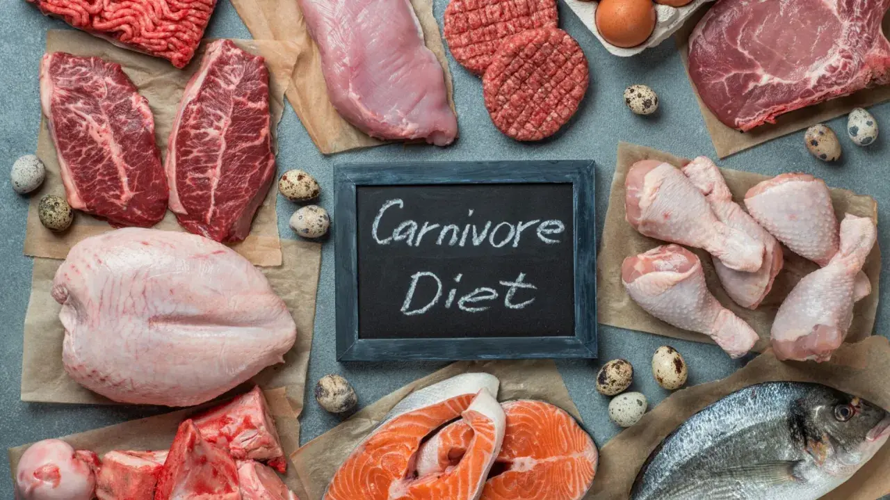 Różnorodne mięsa, ryby i jaja na stole. Tabliczka z napisem "Carnivore Diet" sugeruje, że to inspiracja dla osób szukających efektów diety karniwora.